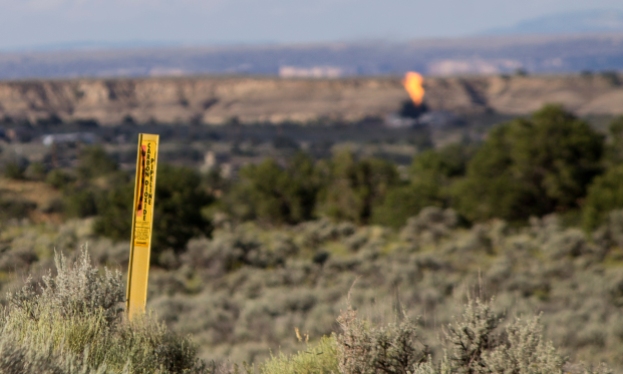 Methane, nitrogen and other gases are flared off at a recently drilled oil well near Nageezi, New Mexico. Carbon dioxide is used to stimulate oil and gas production.